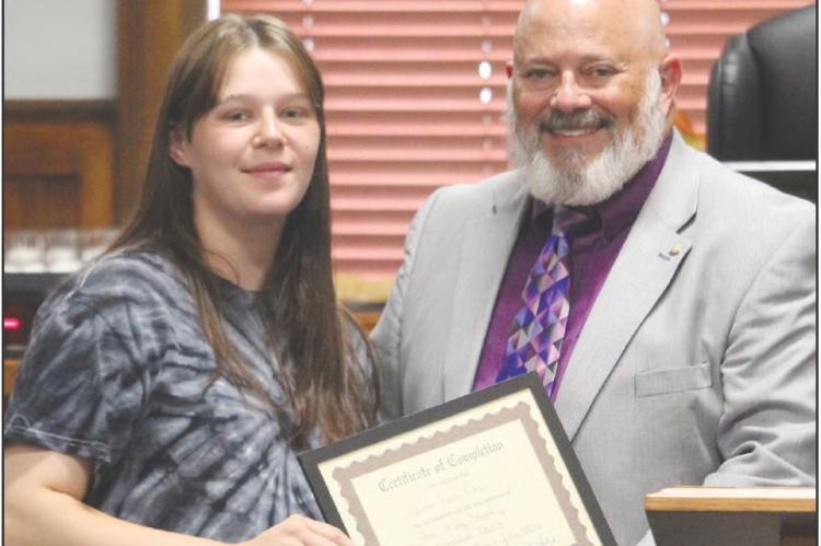 JENNA FISHER (left) receives her Ray County Drug Court graduation certificate from Eighth Judicial Circuit Court Judge Kevin Walden during the program’s 43rd graduation ceremony. MIRANDA JAMISON | Staff