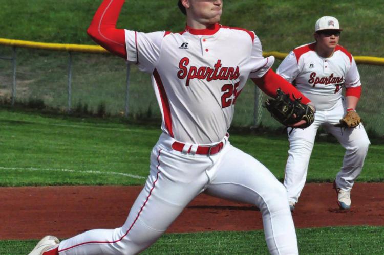 JUNIOR PITCHER Lucas Rodenberg strides toward home plate as he prepares to delivers the pitch. Behind him, junior first baseman Trey Duncan stands ready to make a play Monday afternoon against visiting St. Michael the Archangel at Southview Park. SHAWN RONEY | Staff
