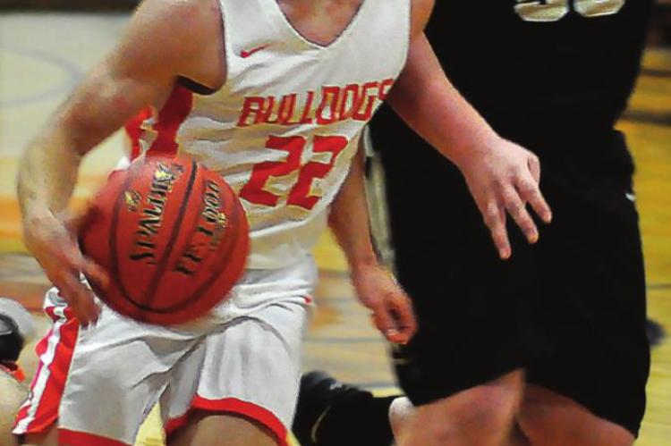 SENIOR KORBIN PUGH drives the floor Monday against Norborne.