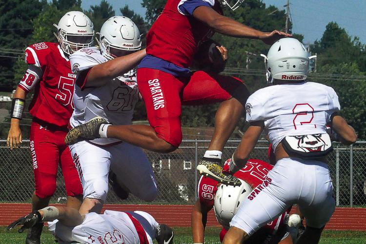 RICHMOND COACH Nick Persell expects Keyshaun Elliott, shown in midair during the 2020 Red and White Game, to apply the knowledge he acquired about quarterbacking in high school to playing linebacker in the NFL. SHAWN RONEY | Staff