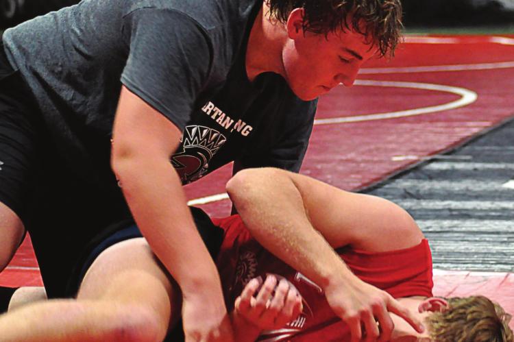 SENIORS ZANE RENFRO, top, and Ryker Plymell, seen practicing their wrestling moves, are looking to return to state competition for the Spartans. SHAWN RONEY | Staff
