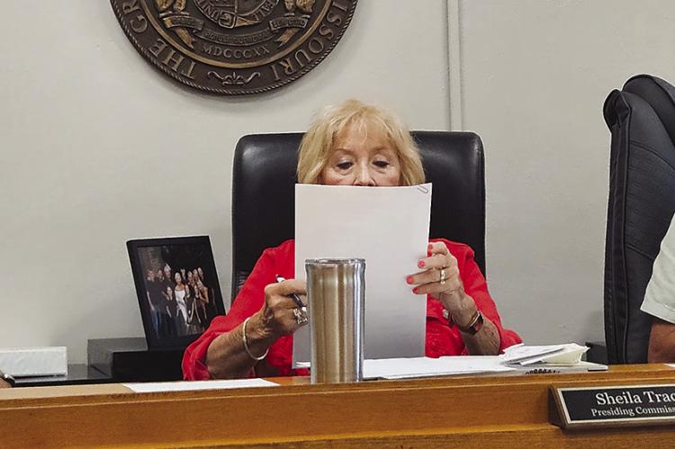 RAY COUNTY COMMISSIONERS Max Hockemeier (from left), Shelia Tracy and Bobby Don Davis review and sign minutes from the commission’s June 17, 18, 24 and 25 meetings. MIRANDA JAMISON | Staff