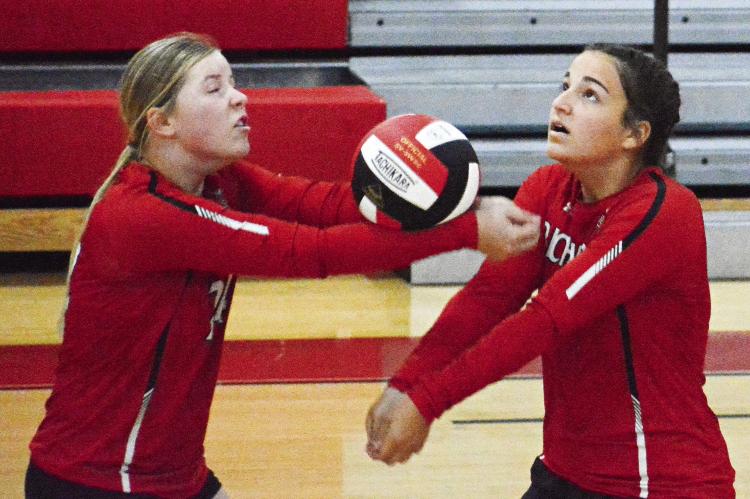 SHAWN RONEY | Staff JUNIOR ALLISON COATS keeps the ball in play with a bump pass and senior teammate Sarah Brungardt is there to back her up Sept. 8 during Richmond’s varsity volleyball match with visiting Orrick.