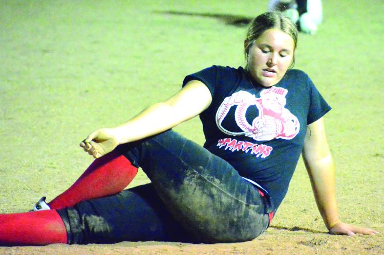 AIREANNA HOEPPNER stretches in the wee hours of Monday morning at Southview Park as she participates in the final midnight practice of her high school softball career at Richmond. SHAWN RONEY | Staff
