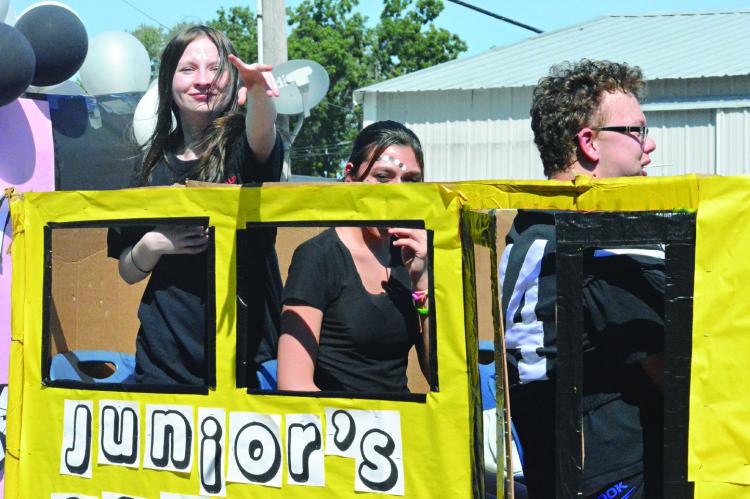 THE JUNIOR CLASS float travels the parade route school bus style.