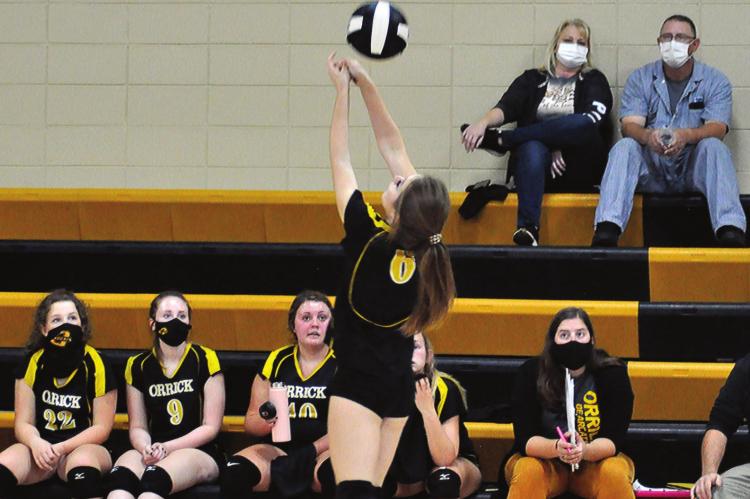 JUNIOR ANNIKA PARKER fights to keep the volleyball in play by bumping it back over her head Monday during Orrick’s non-conference meeting with visiting Mid-Buchanan. SHAWN RONEY | Staff