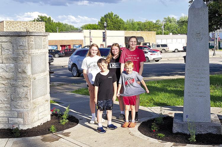 Olde Tyme 4-H members participate in planting flowers at the War Memorials in the Lawson City Park. Submitted