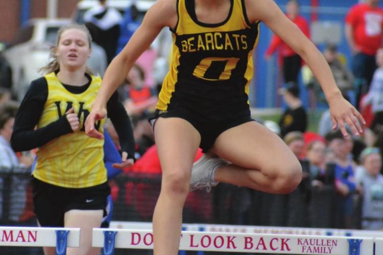 FIRST-YEAR high schooler Anela Fletcher goes airborne in the home stretch of the girls 300-meter intermediate hurdles Tuesday at Lexington.