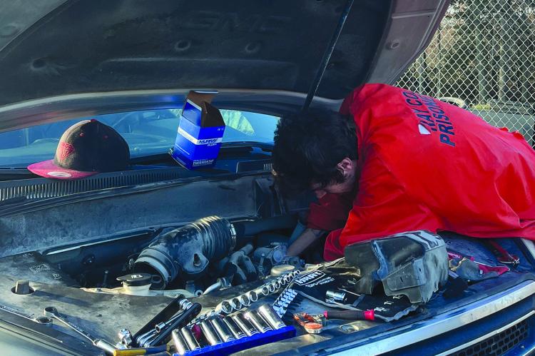 A RAY COUNTY Jail inmate works on a vehicle inside the gated area behind the jail. SOPHIA BALES | Staff