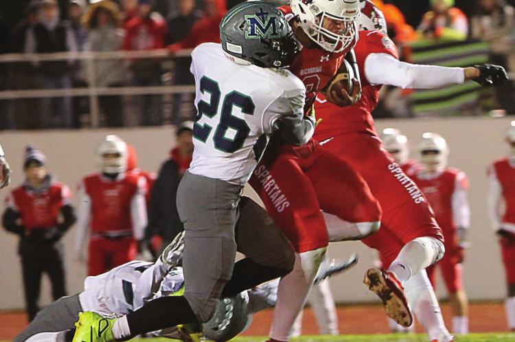 RICHMOND quarterback Keyshaun Elliott rushes for four touchdowns in the District 8 championship game, including busting one for 91 yards. Here he is brought down, with a back-bending opposition effort, after a 33-yard pickup. J.C. VENTIMIGLIA | Staff