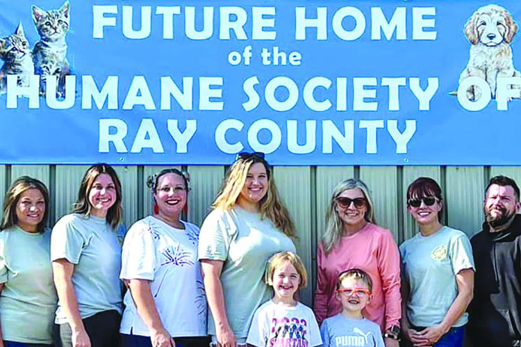 READY FOR A tour of the future location of the Humane Society are Yvette Plymell (back row, from left) Taylee Lyle, Glenda Carter, Atalie Blackwell, Heather Mattox, Maddy Hart, Jennifer Mills, Christi Cromer, Victor DeStefano, Clare Flamank and Amy Pearson, along with Gwendolyn (front row, from left) and Sterling Buck. Submitted