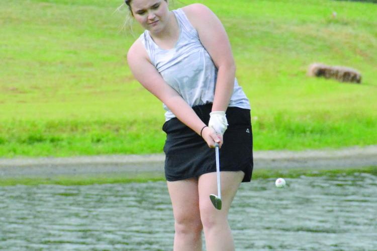 RICHMOND SENIOR Kennedy Wrisinger, hoping to return to state competition, attempts a chip shot as the Spartans practice Aug. 15 at Shirkey Golf Course. SHAWN RONEY | Staff