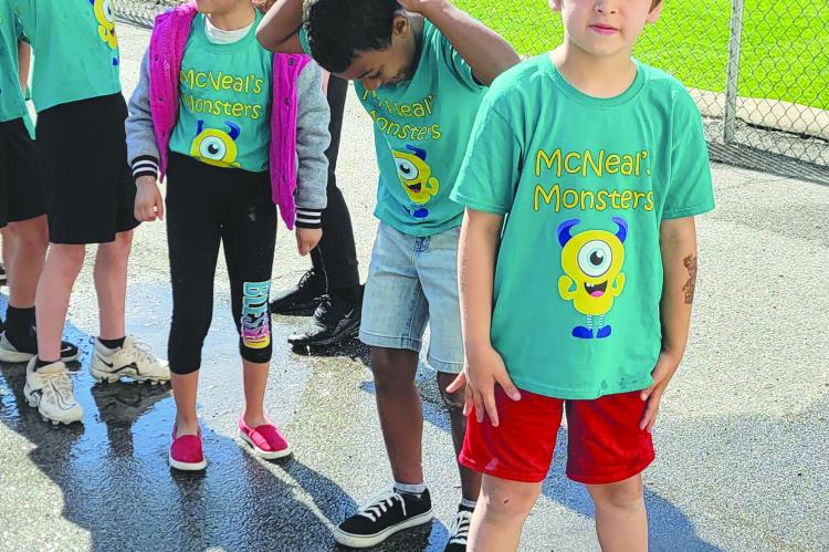 QUAID EDELBROCK (from left), Kenia Lopez and Quinton Gilmore line up behind Manny Martinez to start the water relay while helper Rylen Boyd keeps order. DIANA SHULL | Staff