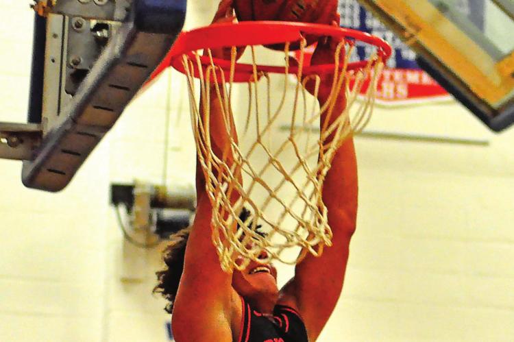 JUNIOR Keyshaun Elliott gets the ball above the rim for a first-half slam dunk Feb. 12 at Lexington. SHAWN RONEY | Staff