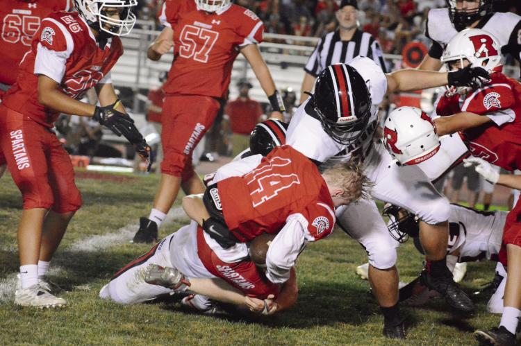 SHAWN RONEY | Staff RICHMOND FIRST-YEAR high schooler Nolan Quick shows he can take a hit as his helmet flies off during a secondhalf rushing attempt Sept. 9 against visiting Marshall.
