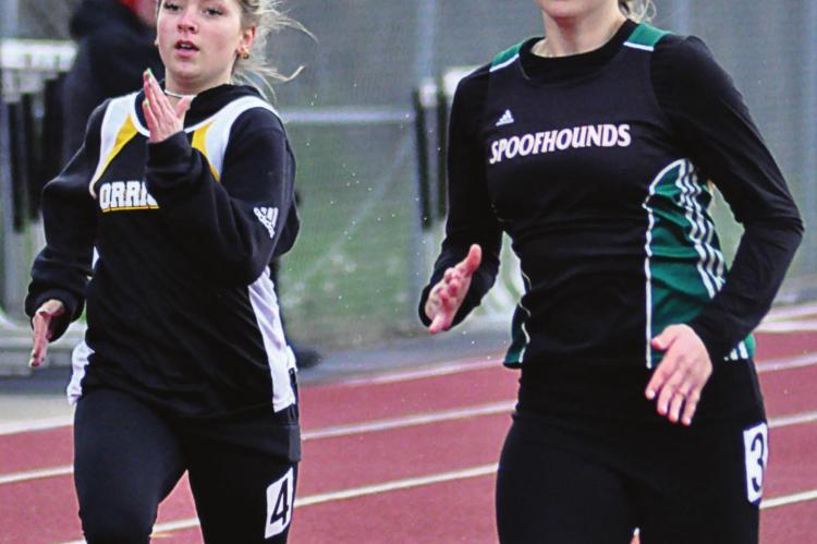KIRRA VAUGHN, left, pushes herself during the girls 200-meter dash. SHAWN RONEy | Staff