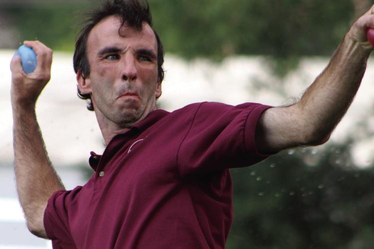 TIM JENKINS WINDS up to launch a water balloon during Community At Play’s annual water fight event. SHARON DONAT | Staff