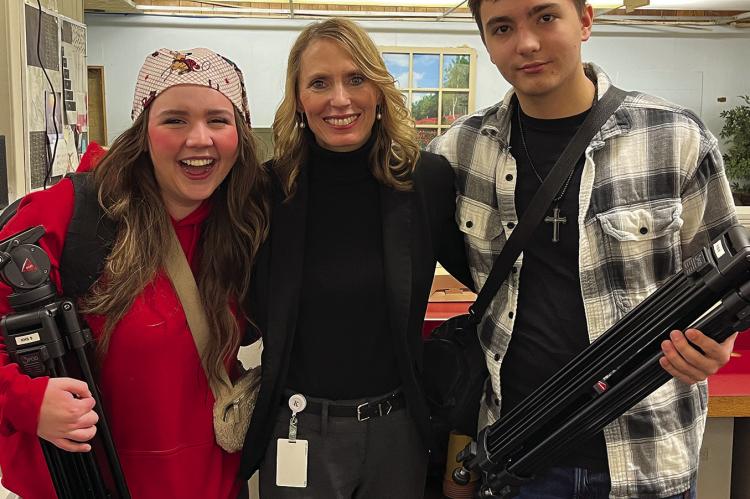 ARMED WITH cameras and tripods Ella Conway (from left), Stacy Holtzclaw and Cody Hoessel ask questions about journalism and the newspaper business. SOPHIA BALES | Staff