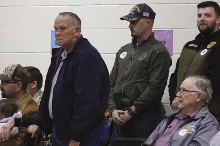 STANDING, JIM MISENHELTER (standing, from left), David Savage and Theodore White participate as their branch is announced.