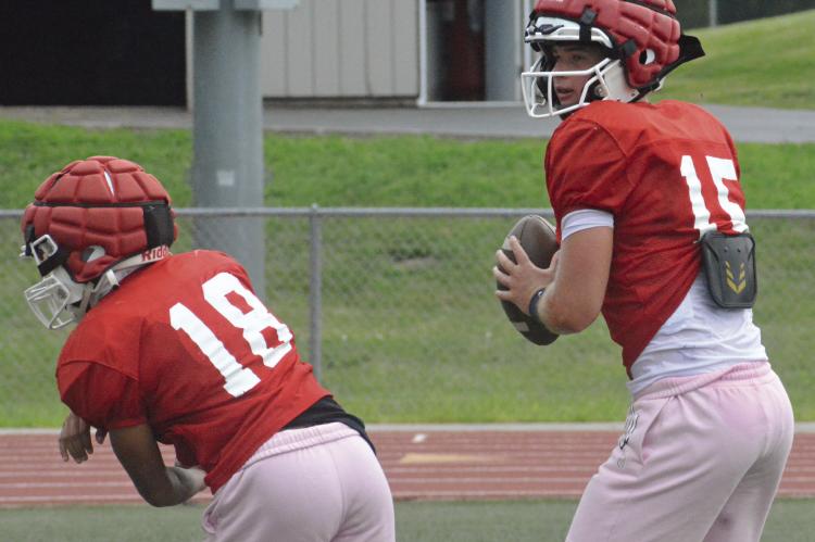 RICHMOND QUARTERBACK Jacob Lieberknecht (right) looks downfield after executing a play-action fake during offseason scrimmaging. SHAWN RONEY | Staff