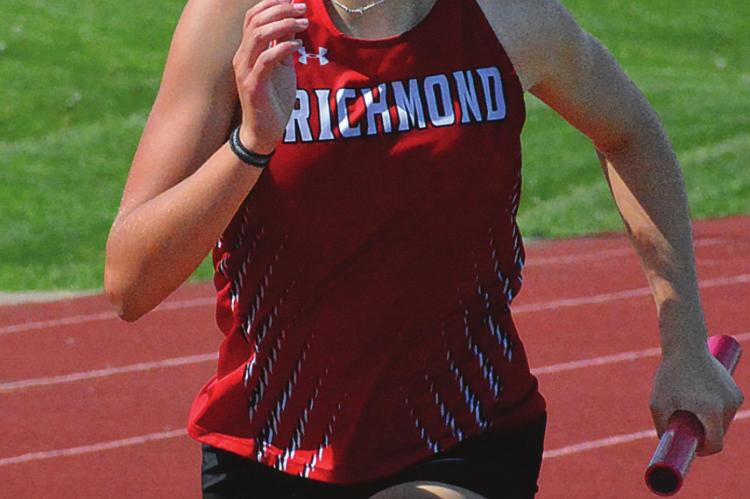 A FEW HOURS after helping to set the school record in the girls 800-meter relay, Kaylee Pugh runs in the 1,600 relay in district competition. SHAWN RONEY | Staff
