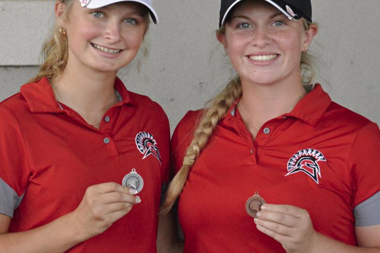 RICHMOND SOPHOMORE Lyla Best (left) and junior Karoline Dooley display their medals for placing in the top 10 at the Richmond Invitational. SHAWN RONEY | Staff