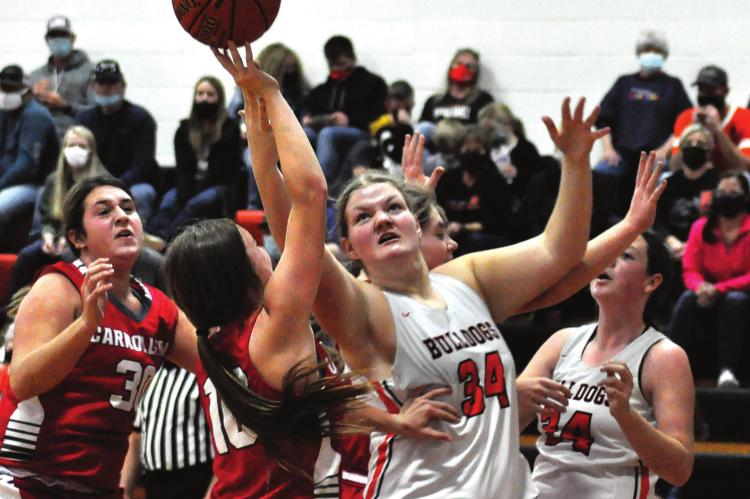 JUNIOR MORGAN FINLEY tries to grab a rebound for the Bulldogs during their Dec. 5 loss to visiting Carrollton, a fill-in opponent because Braymer could not play Hardin-Central. SHAWN RONEY | Staff