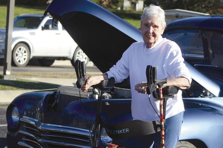 A CLASSIC CAR catches the attention of Marjie Jones during Fall Fest. SHARON DONAT | Staff