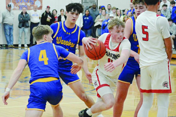 RICHMOND JUNIOR Nolan Quick (center) drives through the St. Pius X defense while teammate Brice Dome (right) sets a pick for him during Class 4 District 15 boys title game action. SHAWN RONEY | Staff