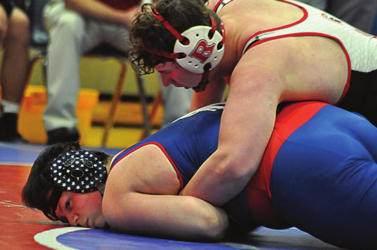 LARRY PENNISON of Richmond works to break down Spencer Fox Jan. 6 in dual action at Lexington. SHAWN RONEY | Staff