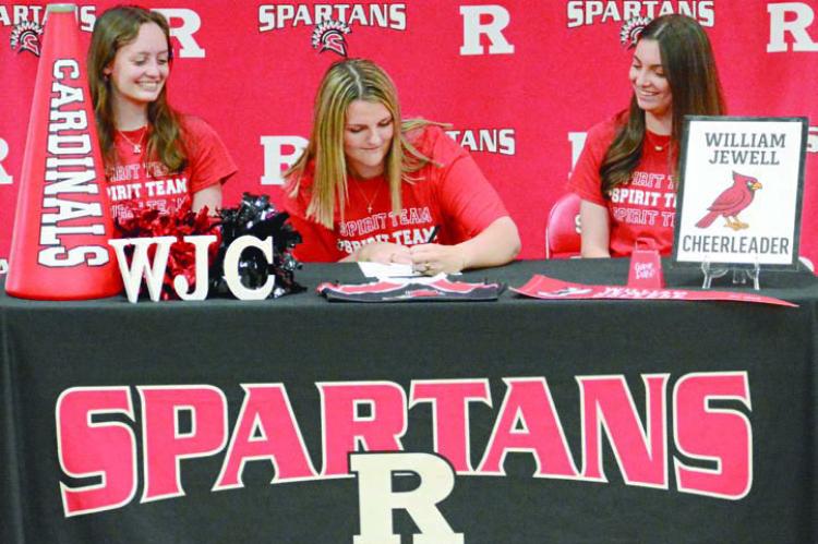 LILY SUMMERS (center) is going from cheering on the Spartans at Richmond High School to cheering on the Cardinals at William Jewell College. SHAWN RONEY | Staff