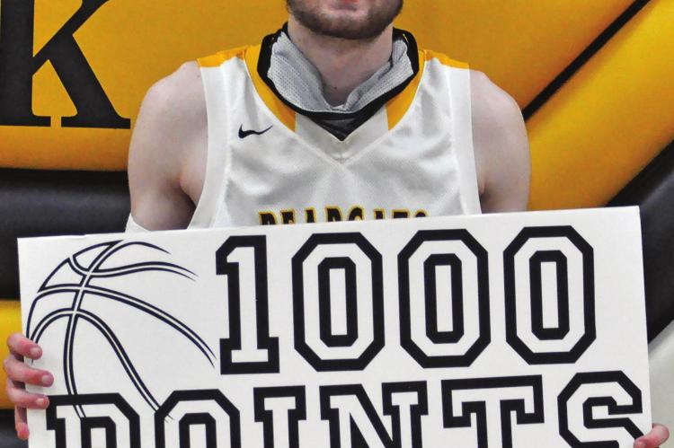 ORRICK SENIOR Dylan Comstock enjoys achieving a career milestone Tuesday after the Bearcats’ 64- 41 Class 1 District 13 Tournament victory over visiting Norborne. SHAWN RONEY | Staff