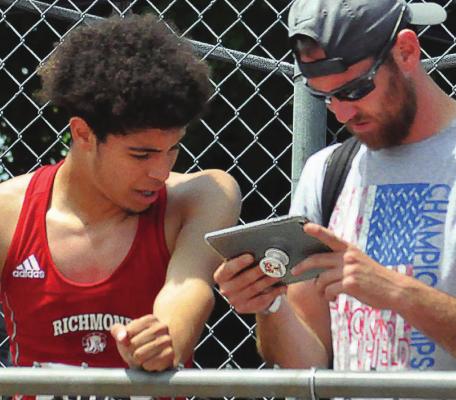 RICHMOND student-athlete Dionte Marquez, reviewing his technique with jumpers coach Jacob Swope at the 2019 Class 3 state track and field meet SHAWN RONEY | Staff in Columbia, looks to continue his athletic career at the University of Central Missouri in Warrensburg. Swope plans to follow Marquez’s career at UCM.