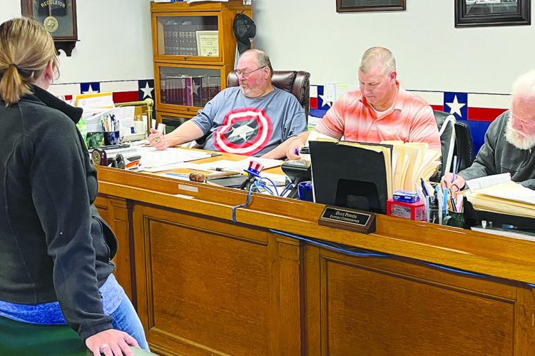 HEATHER MAULSBY GRAFF (left) discusses business with Ray County Commissioners Gary Wilhite, Billy Gaines and Dave Powell. SOPHIA BALES | Staff