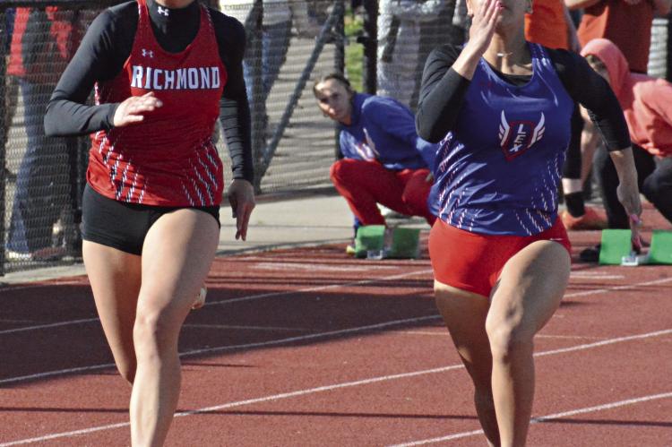 KAYLEE PUGH (left) fights off a challenge from LaNiya Davis in the girls 100-meter dash during the Bill Hamann Invitational April 11 at Lexington. SHAWN RONEY | Staff