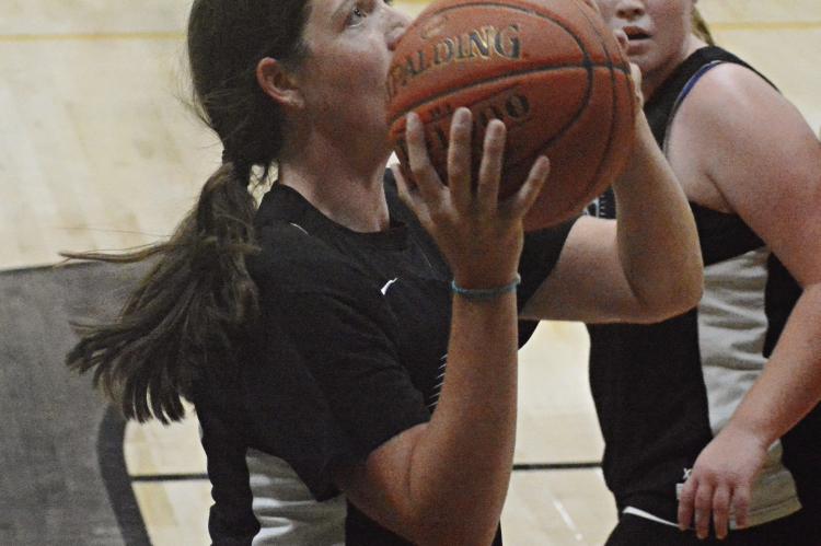 LIBBY FIFER takes aim near the bucket as she and her Hardin-Central teammates scrimmage against Orrick in varsity girls basketball July 13 in the Orrick High School gym. SHAWN RONEY | Staff