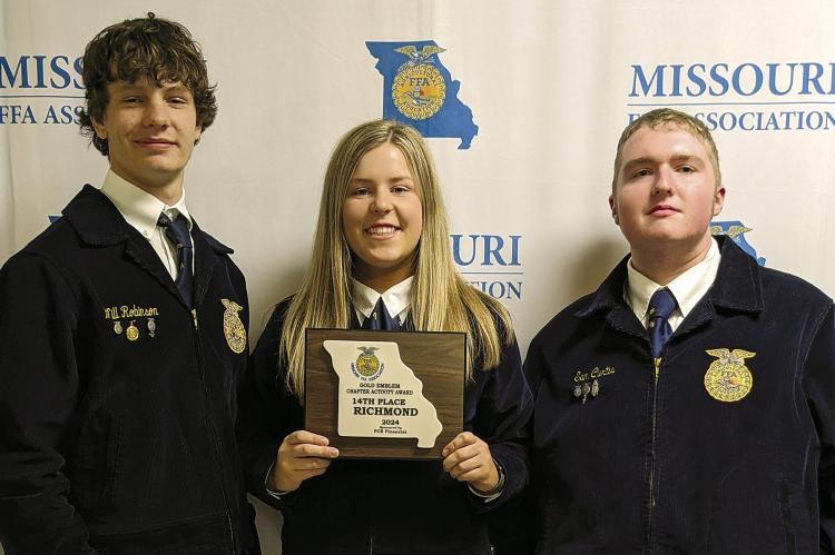 WILL ROBINSON (from left), Allison Coats and Sam Curtis receive an award for 14th place. Submitted