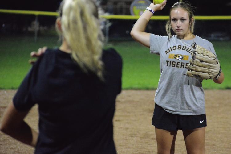JUNIOR KYNLEE LOPEZ throws while participating in a short toss drill as she and her Richmond teammates hold their Midnight Madness practice Aug. 7 at Southview Park to get their latest varsity softball campaign underway. SHAWN RONEY | Staff