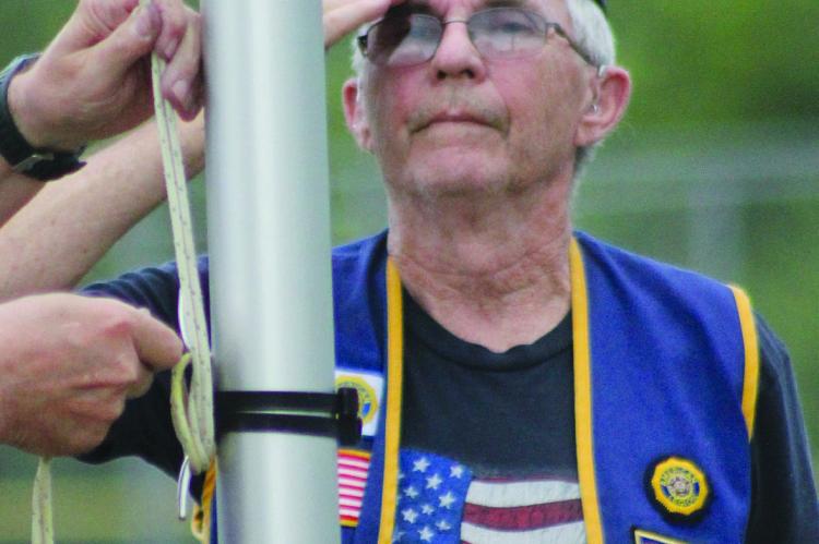 American Legion Outgoing Commander Jim Richardson salutes as American Legion Incoming Commander Jack Lauck raises the flag. The duo participated in Richmond’s Annual American Celebration. SOPHIA BALES | Staff