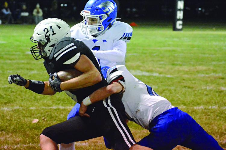 GAGE SMITH, sporting No. 21 on his helmet but a No. 10 jersey, fights for yards during the first half of Norborne Hardin-Central’s District 4 Tournament meeting with the Southwest co-op Nov. 3 at Hardin-Central. SHAWN RONEY | Staff