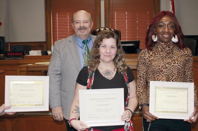 RAY COUNTY PRESIDING JUDGE Kevin Walden is with Drug Court graduates Leeanna Grieme and Natalia Mays. Due to Melissa Sollar’s absence from the ceremony, Prosecuting Attorney Camille Johnston holds Sollar’s certificate. SOPHIA BALES | Staff