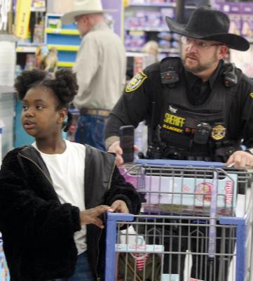 ROYALTY (LEFT) and RCSO Deputy Brian Lackey begin shopping.