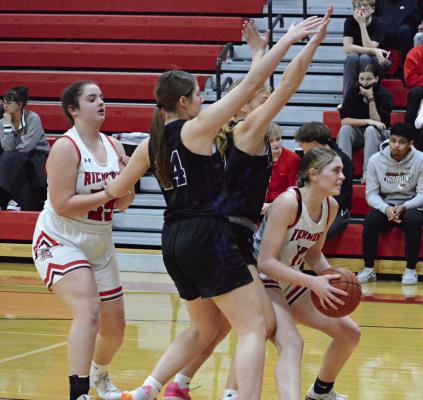 WITH RICHMOND TEAMMATE Paige Logsdon and two Bishop LeBlond of St. Joseph defenders behind her, sophomore Candiace Claypole looks to shoot in the post during Winter Classic action Monday night at Richmond High School. SHAWN RONEY | Staff