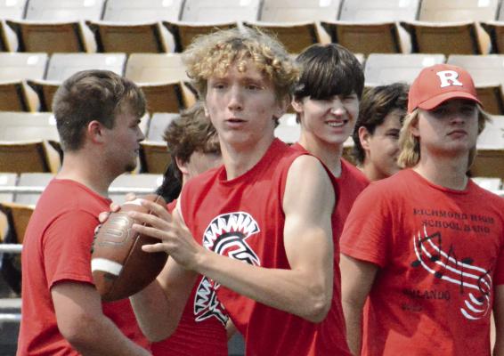 TAKING REPS at quarterback, Jacob Johnson looks to his right for a potential receiver during 7-on-7 scrimmaging Tuesday morning at Tiger Stadium in Excelsior Springs as some of his Richmond teammates watch. SHAWN RONEY | Staff