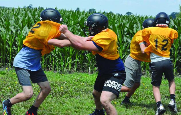 BLOCKING IS one of the skills Orrick’s varsity football players practice during a junior high and varsity camp session Monday on the practice field. SHAWN RONEY | Staff