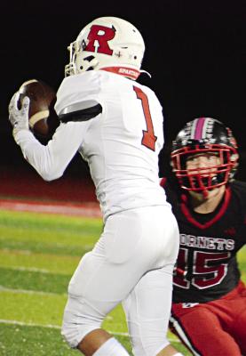 DRYDEN HENDRIX, a first-year high schooler at Richmond, hauls in a short pass from Spartans quarterback Jacob Lieberknecht during the first half of Class 3 District 8 Tournament play Oct. 27 at Chillicothe. SHAWN RONEY | Staff