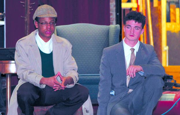 ZAVIER DAVIS (left) as Sherlock Holmes looks for clues with Jazspher Ulleburg playing Watson during RHS spring play rehearsal at the Farris Theatre. “Holmes and Watson: The Game’s Afoot” will be presented March 13 and 14 at 7:00 p.m. and 2:00 p.m. on Sunday March 15. SHARON DONAT | Staff