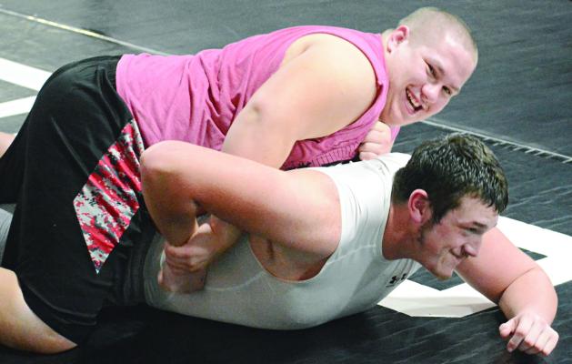 SEBASTIAN SVEISTRUP (top) and Travis Cardwell seem to be having fun as they practice their wrestling moves. SHAWN RONEY | Staff
