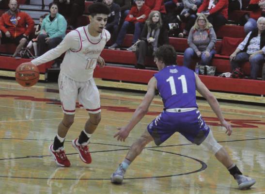 SENIOR DIONTE MARQUEZ, seen here dribbling during a late January game at Richmond High School, has been named a Class 3 all-state basketball selection.