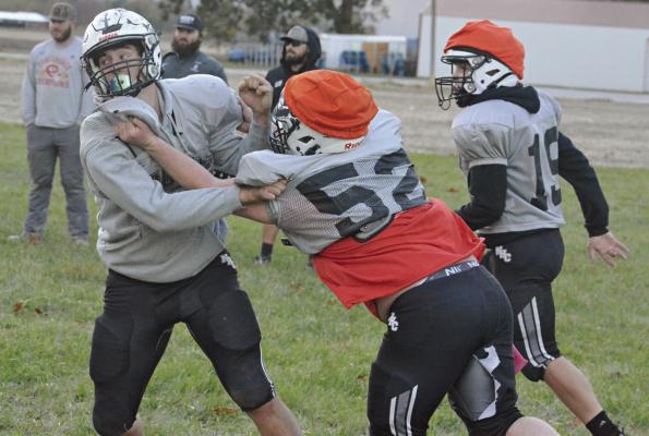GAGE SMITH (left) fights through a block by Jace McNelly on the practice field at Hardin-Central. SHAWN RONEY | Staff